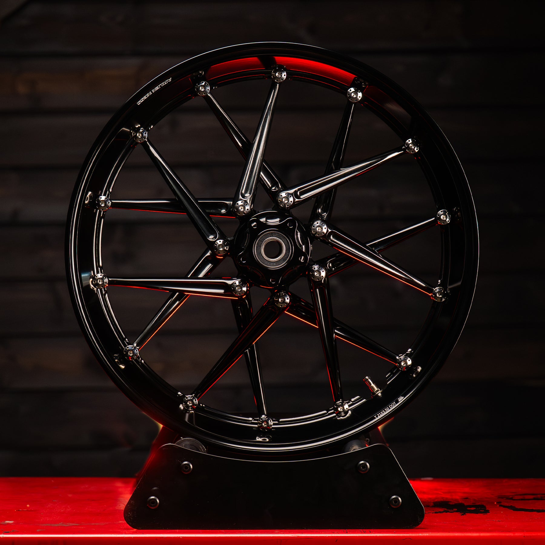 Arlen Ness Spoken black forged wheel styled in an environmental product shot